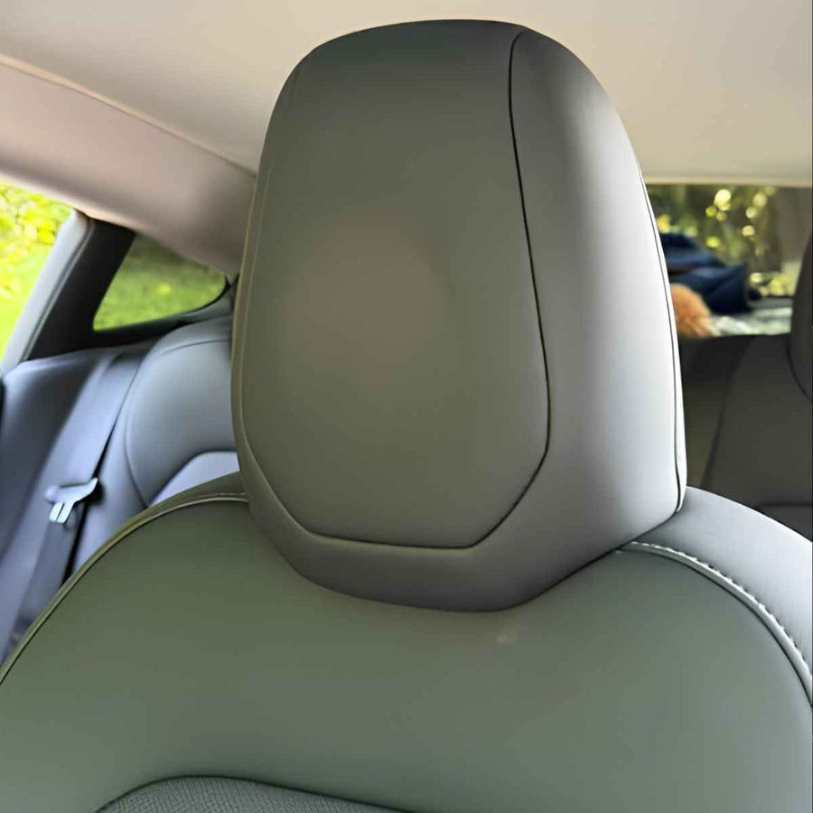 Front seat with integrated headrest